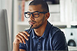 man looking at a laptop