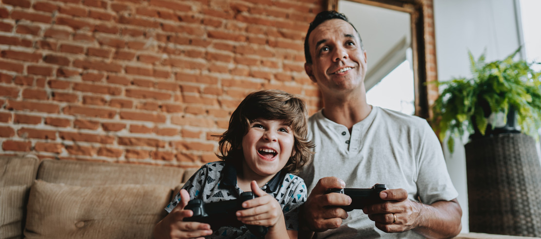 man playing video games with little boy