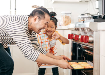 man baking with child