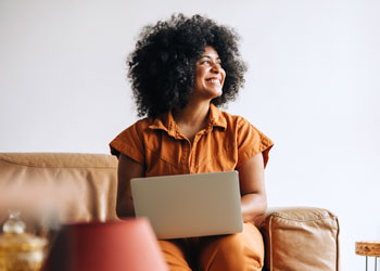 woman on laptop researching 6 month CDs