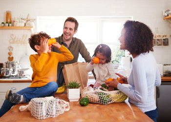 family in their kitchen laughing