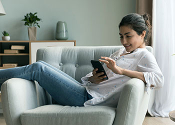 woman relaxing and looking at phone