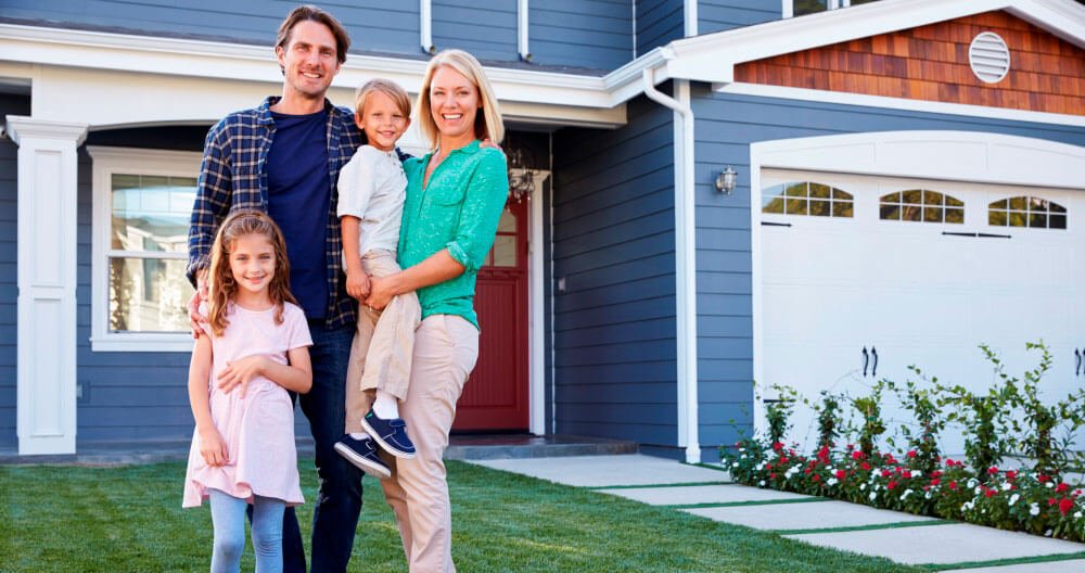 family in front of their house