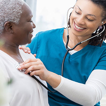 nurse using stethoscope on patient