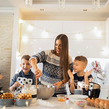 mom and two kids baking cookies