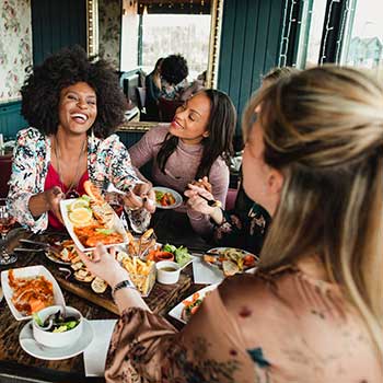 friends eating together at restaurant