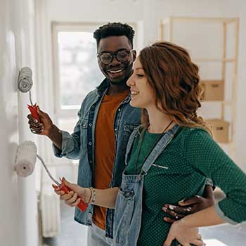 young couple painting home