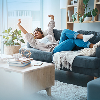 young woman stretching on couch