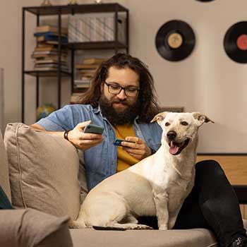 man on couch with dog