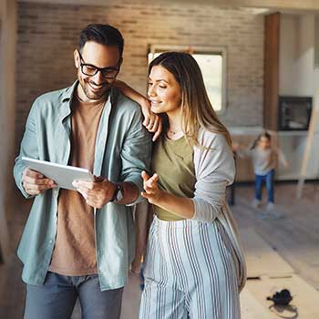 couple looking at tablet in home