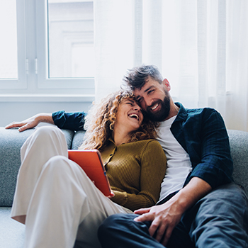 couple sitting on floor looking at paperwork