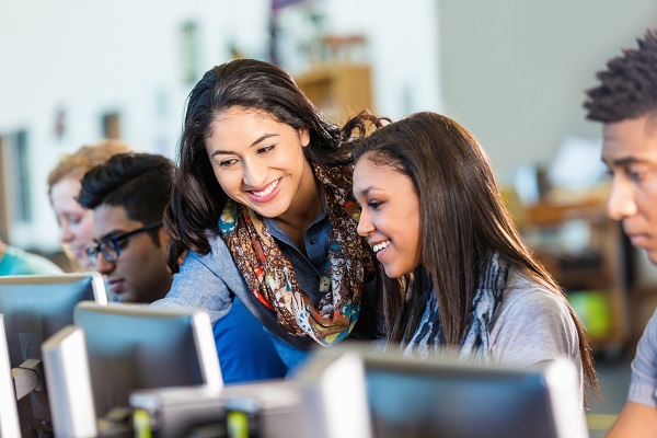 college students looking at computers