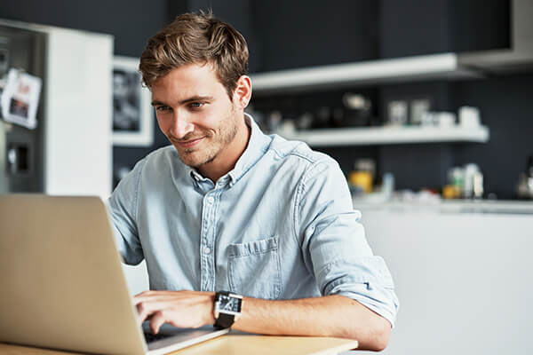 man surfing net on laptop