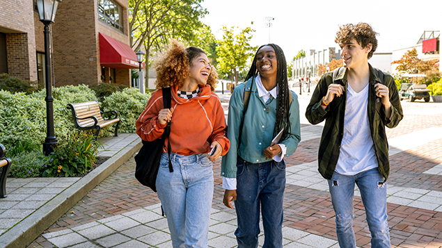 teenagers walking with backpacks