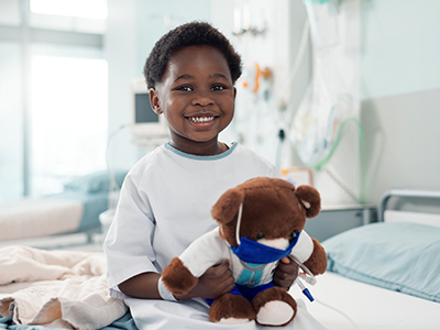 young child in hospital with stuffed animal