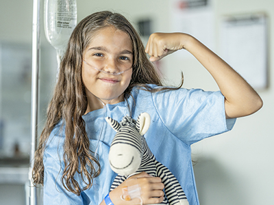 young girl in hospital with stuffed animal