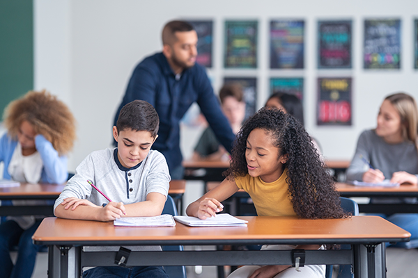 two middle school students at a desk